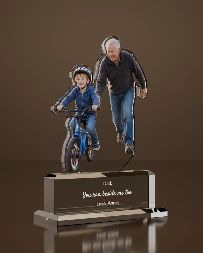 Render of the finished Ovvie: the same two, cut in clear glass. On the base, in white lettering: "Dad," "You ran beside me too" and "Love, Annie".